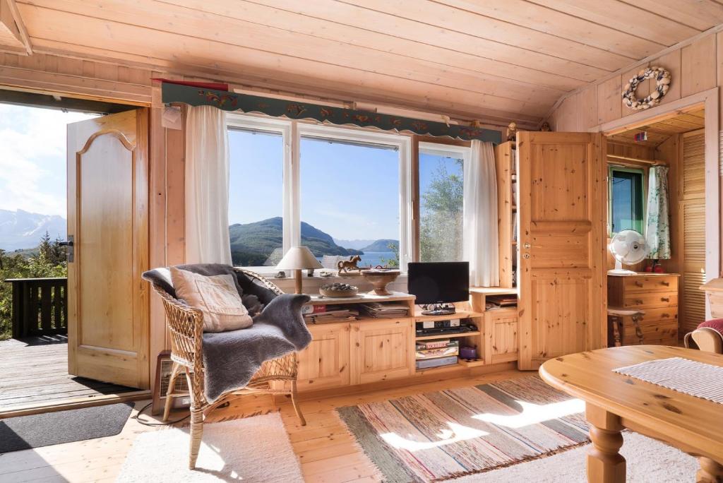 a living room with a desk and a large window at Cabin - Sleeps 6 - Pets Ok - Pato - Parking in Ørnes