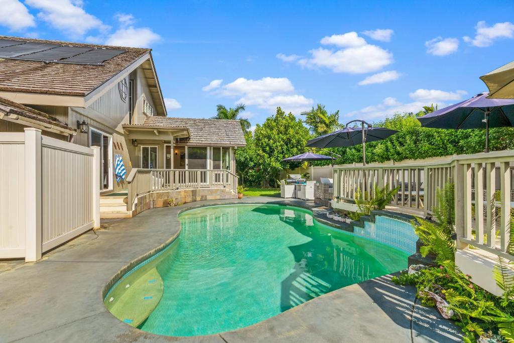 a swimming pool in the backyard of a house at Emmalani 3BR Princeville Villa with Private Pool in Princeville
