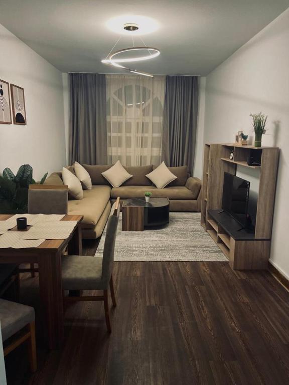 a living room with a couch and a tv and a table at Beach breeze in Essaouira