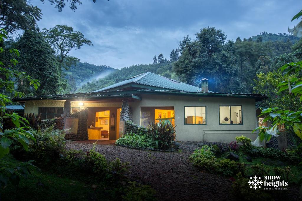 a small house in the middle of a forest at Snow Heights Lodges in Kasese