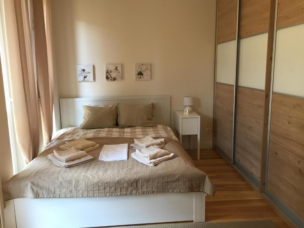 a bedroom with a bed with towels on it at Apartament z Tarasem in Świnoujście