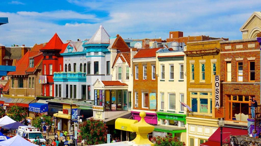 a city with many colorful buildings and a yellow statue at 3 Level 4 Bedroom Home w/ Parking in Adams Morgan in Washington, D.C.