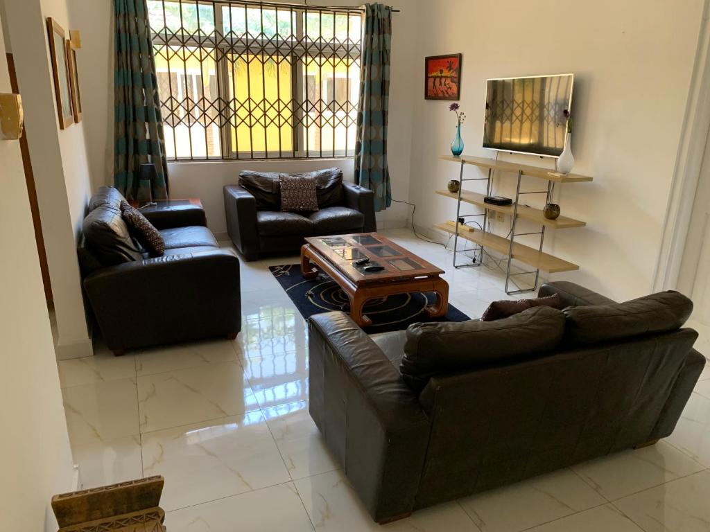a living room with two couches and a coffee table at Accra Service Villas- 3 in Spintex