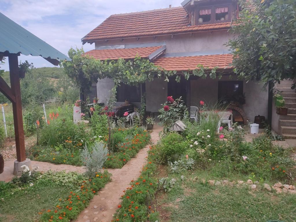 a garden in front of a house with flowers at Soko Mara in Soko Banja