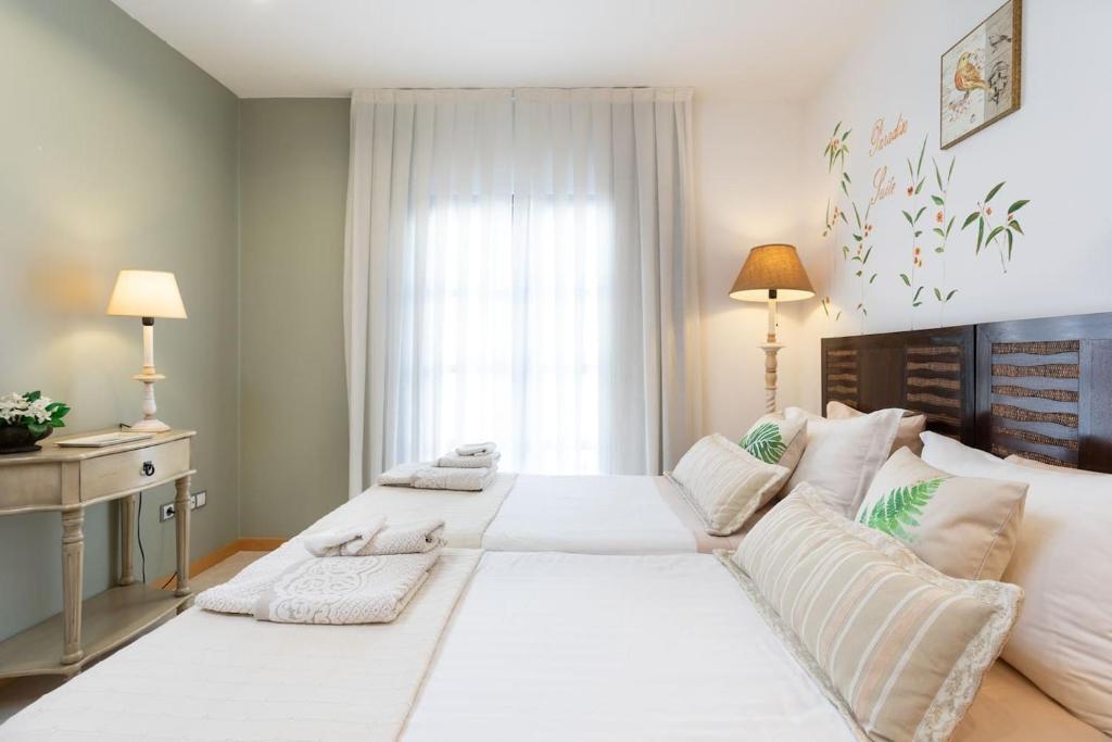 a large white bed in a room with a window at The Paradise suites by ANNE, Cozy apartment in Adeje in Adeje