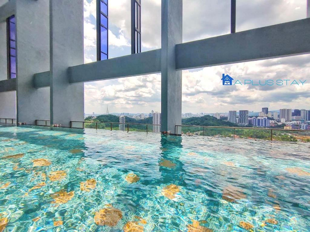 a swimming pool on the top of a building at Millerz Square by A Plus Stay in Kuala Lumpur