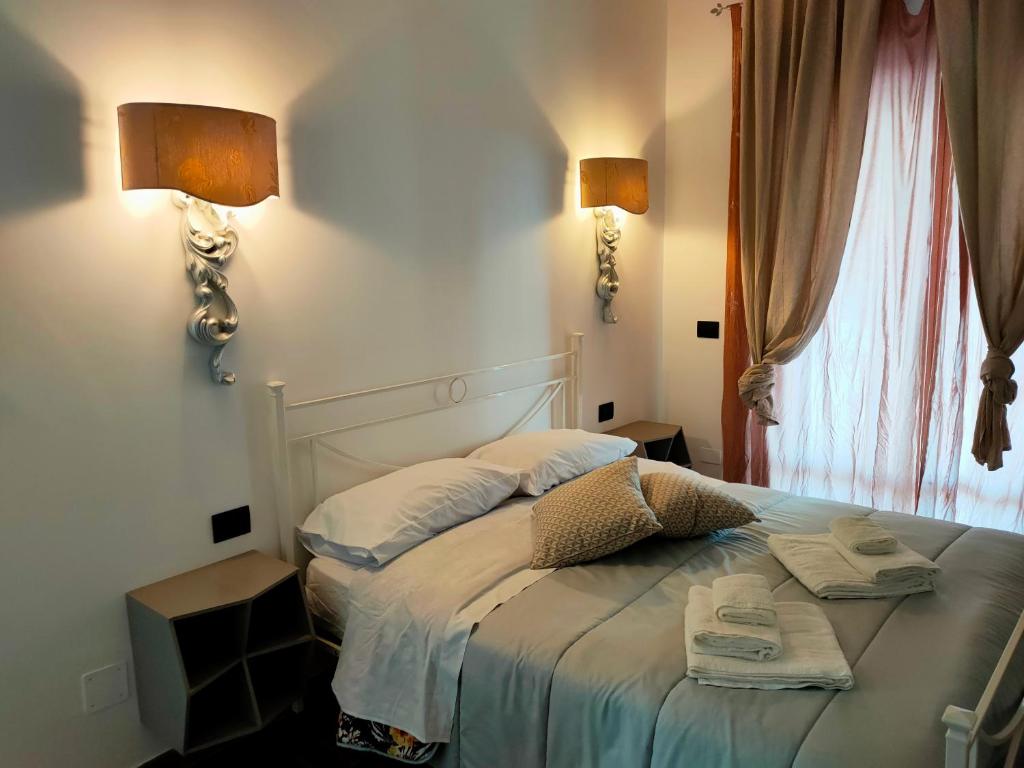 a bedroom with a bed with two towels on it at Villa Picarielli in Salerno