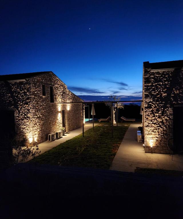 a night view of a building with lights on it at Elaionas Estate Perdika in Perdika