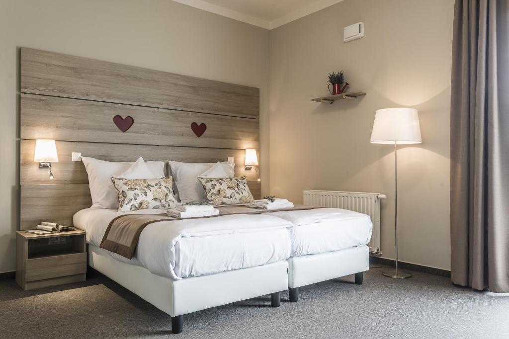 Postel nebo postele na pokoji v ubytování Levendula Hotel