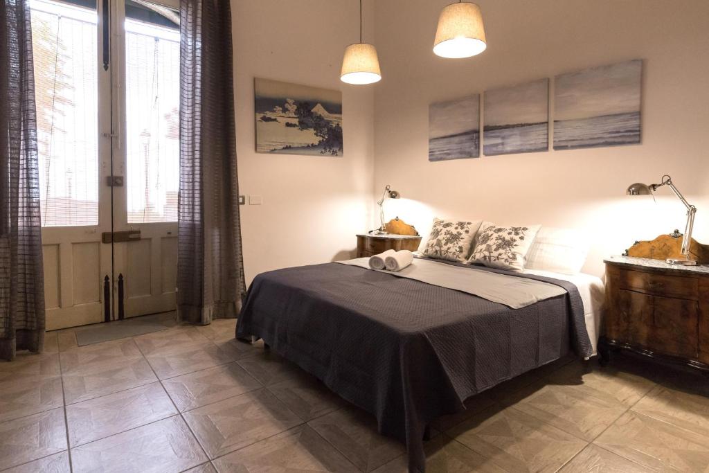 Postel nebo postele na pokoji v ubytování Al Palazzetto di Milo
