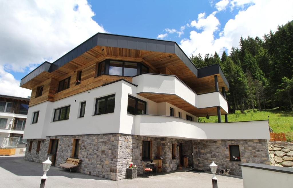 a house with a wooden roof at Chasa Patria in Ischgl