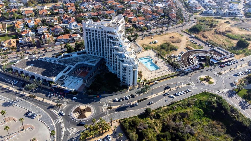 an aerial view of a building in a city at Tamara Ashkelon Hotel in Ashqelon