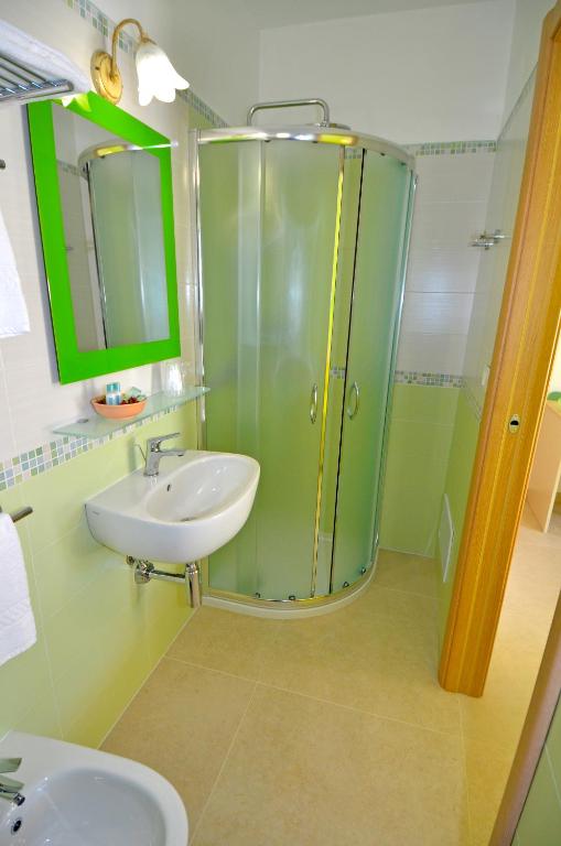 a bathroom with a glass shower and a sink at B&B Lu Cantoru in Marina di Pescoluse