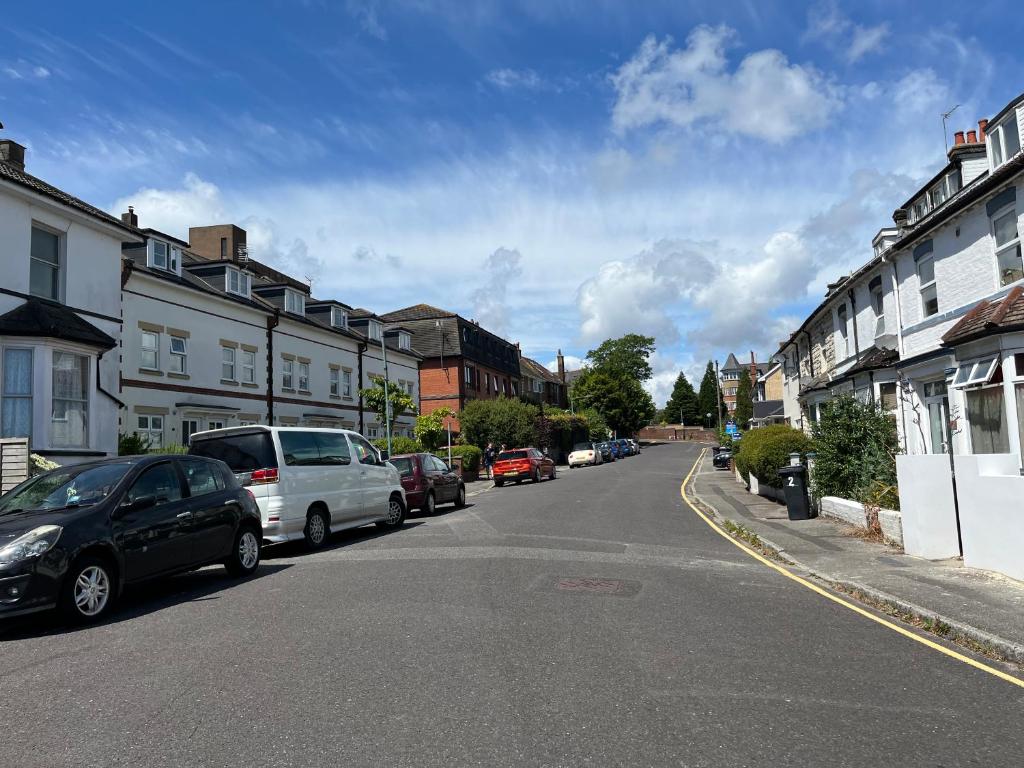 a city street with cars parked on the side of the road at Town centre White House in Bournemouth