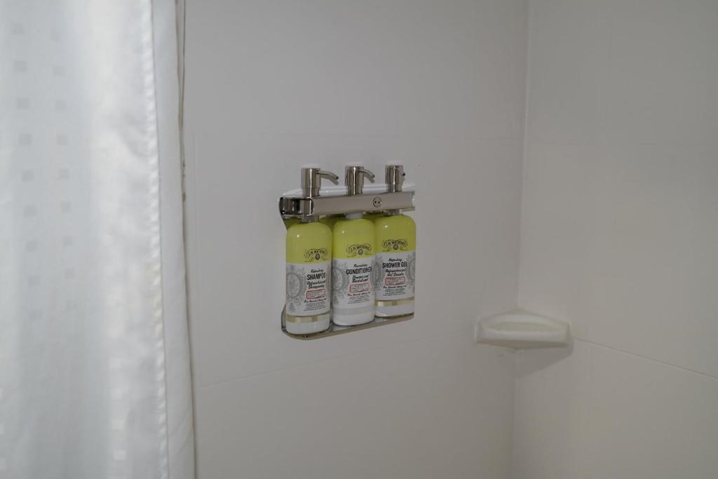 a white door with three bottles on it at Holiday Inn Express Fredericksburg - Southpoint by IHG in Fredericksburg