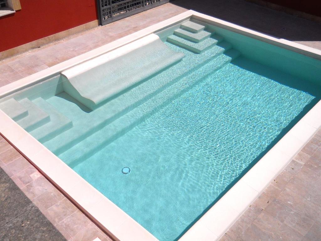 a large swimming pool with a poolvisorvisor at Bio Casale Marchesi in Casarano