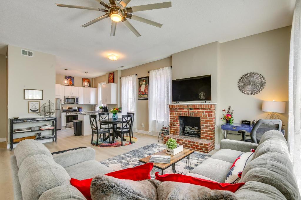 a living room with a couch and a fireplace at St Louis Vacation Rental about 2 Mi to Downtown in Soulard