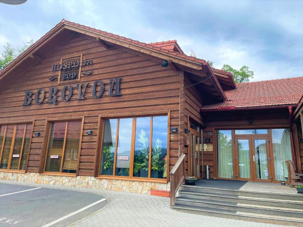 a building with a sign on the front of it at Ubytování Pod Borovou in Malenovice