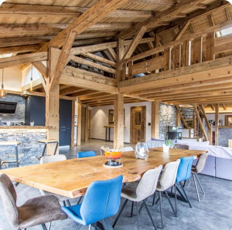 a large dining room with a wooden table and chairs at Chalet Le Perray Alpine Lodge in Abondance