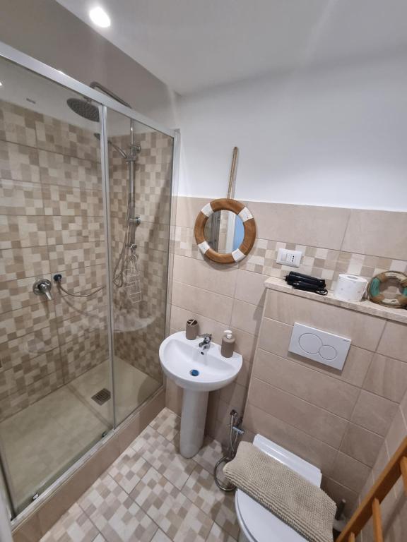 a bathroom with a shower and a toilet and a sink at My Room Roma 2 in Lido di Ostia
