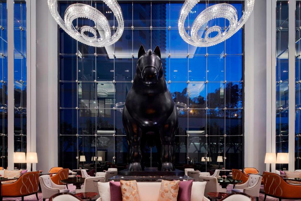 a statue of a horse on a table in a restaurant at The St. Regis Kuala Lumpur in Kuala Lumpur
