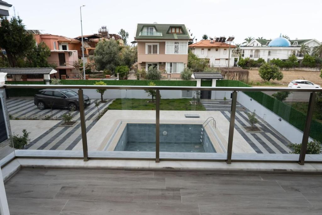 a view from the balcony of a house with a swimming pool at Amore Hotel Teki̇rova in Tekirova