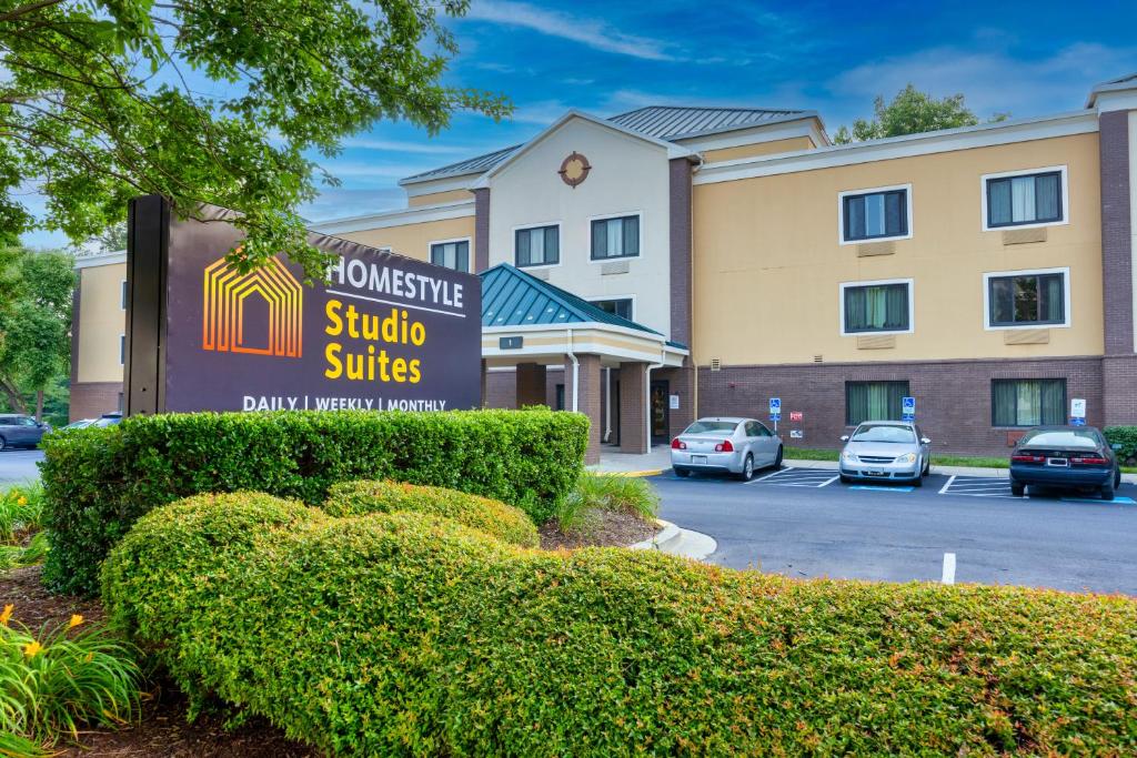 a hotel sign in front of a building at Homestyle Studio Suites in Annapolis