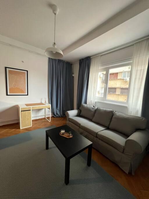 a living room with a couch and a table at Apartament Ultracentral Universitate in Bucharest