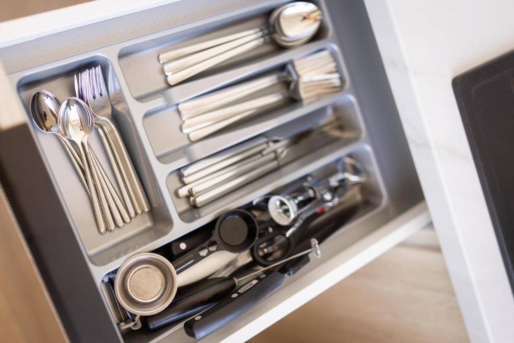 a tool box with utensils in it at Windy City apartments in Liepāja