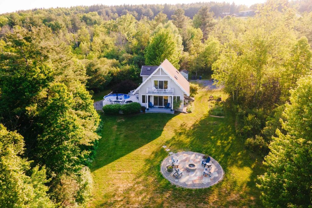 an aerial view of a white house in the woods at Charming Hammondsport Home with Lake Views and Pool! in Hammondsport