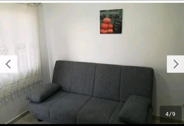 salon z kanapą i zdjęciem pomarańczy w obiekcie Corralejo city beach w Corralejo