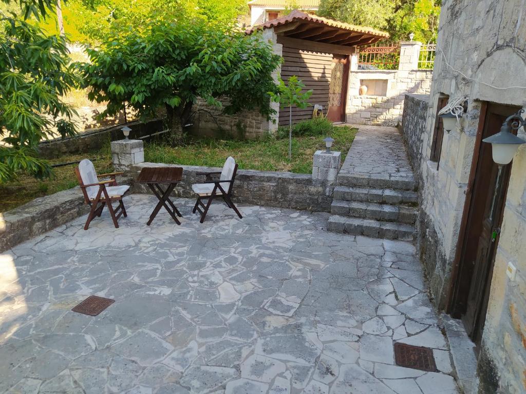 a patio with two chairs and a table and a table at Beautiful little stone house! 