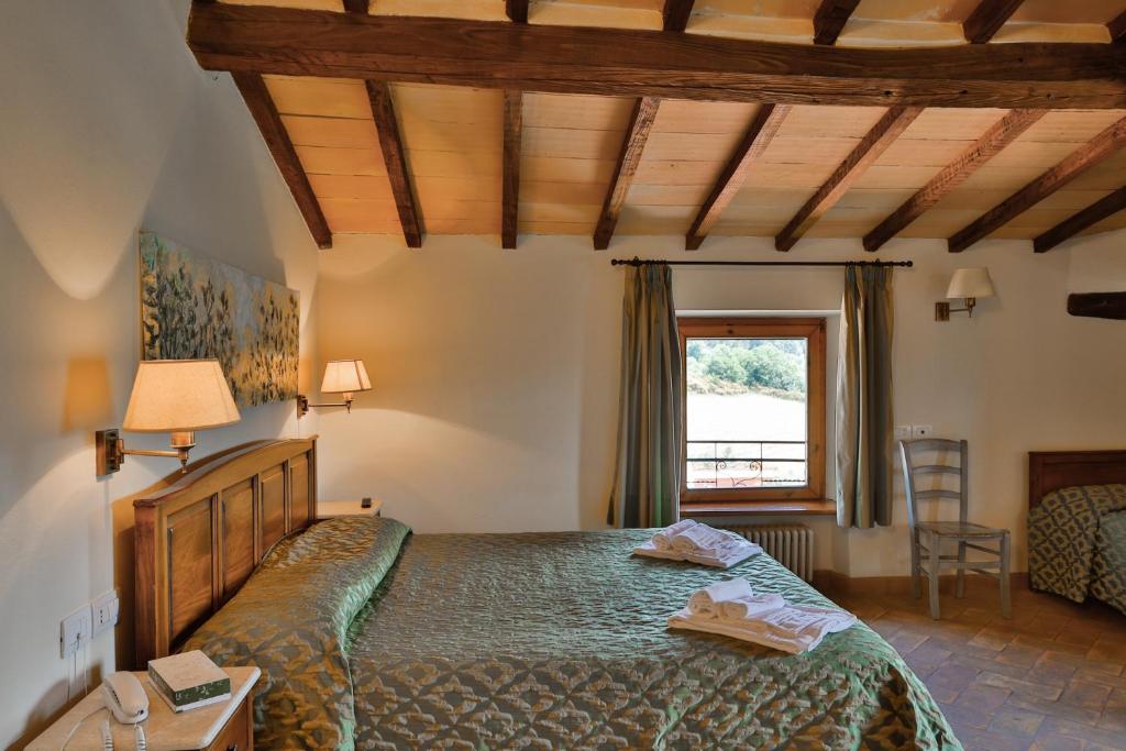 Posteľ alebo postele v izbe v ubytovaní Hotel Relais Santa Genoveffa
