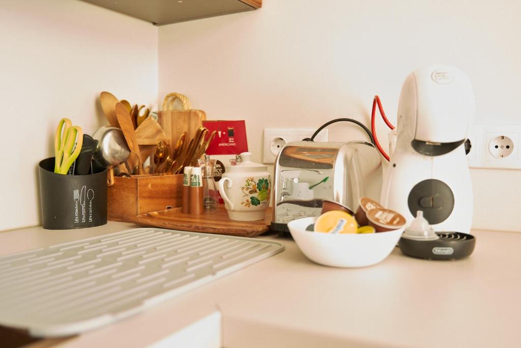 a kitchen counter with a keyboard and various kitchen utensils at Amalie Apartment in Haapsalu