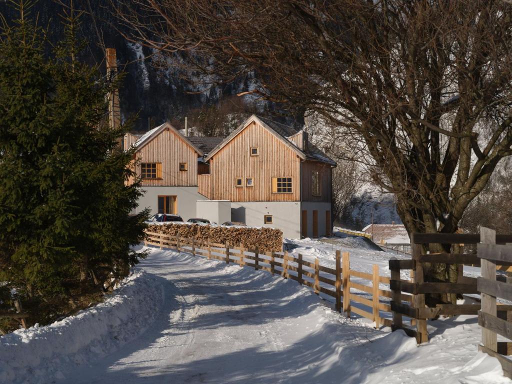 a barn in the snow next to a fence at IKI Retreat Magura in Măgura