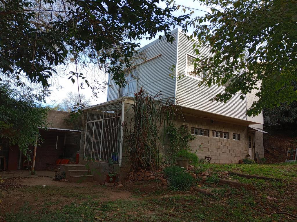 a house with a gate in front of it at Casa en Río Ceballos. Muy buena ubicación. in Río Ceballos