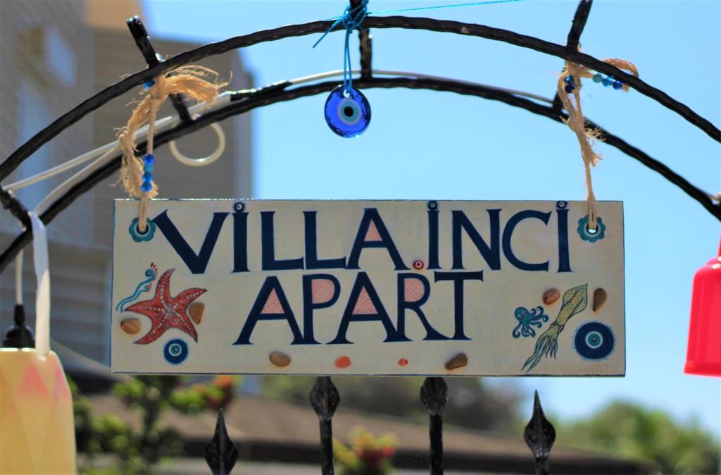 a sign for a villinian agent hanging on a fence at Villa İnci in Çeşme