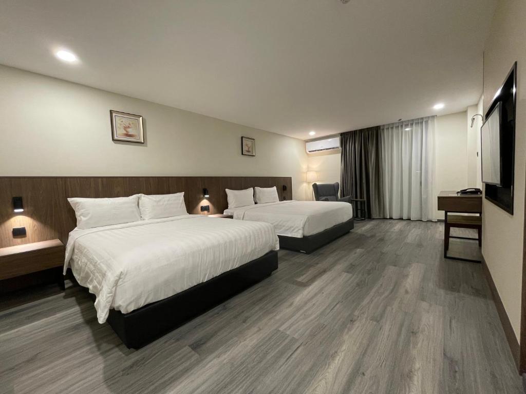 Postel nebo postele na pokoji v ubytování Hotel Bundusan