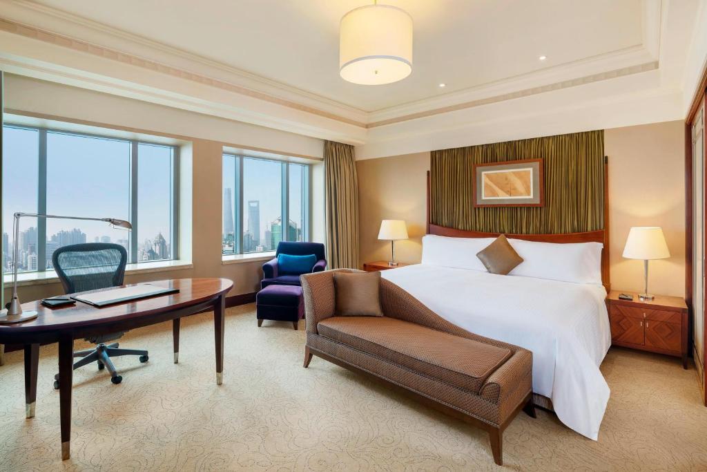 a hotel room with a bed and a desk and chair at The Hongta Hotel, A Luxury Collection Hotel, Shanghai in Shanghai