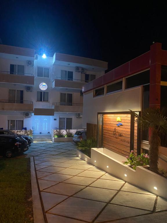 a parking lot in front of a building at night at Ajan Apartments in Ulcinj