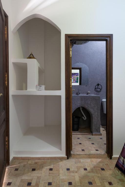 a bathroom with a sink and a mirror at Riad SULTANA in Tangier