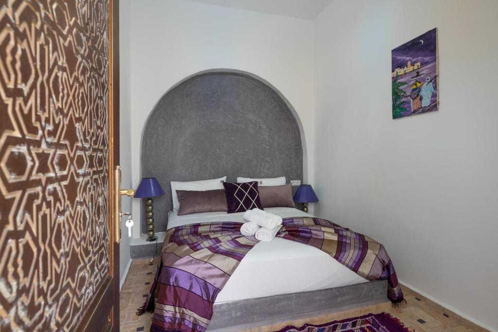 a bedroom with a bed with a teddy bear on it at Riad SULTANA in Tangier