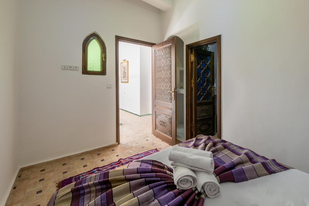 a bedroom with a bed with two towels on it at Riad SULTANA in Tangier