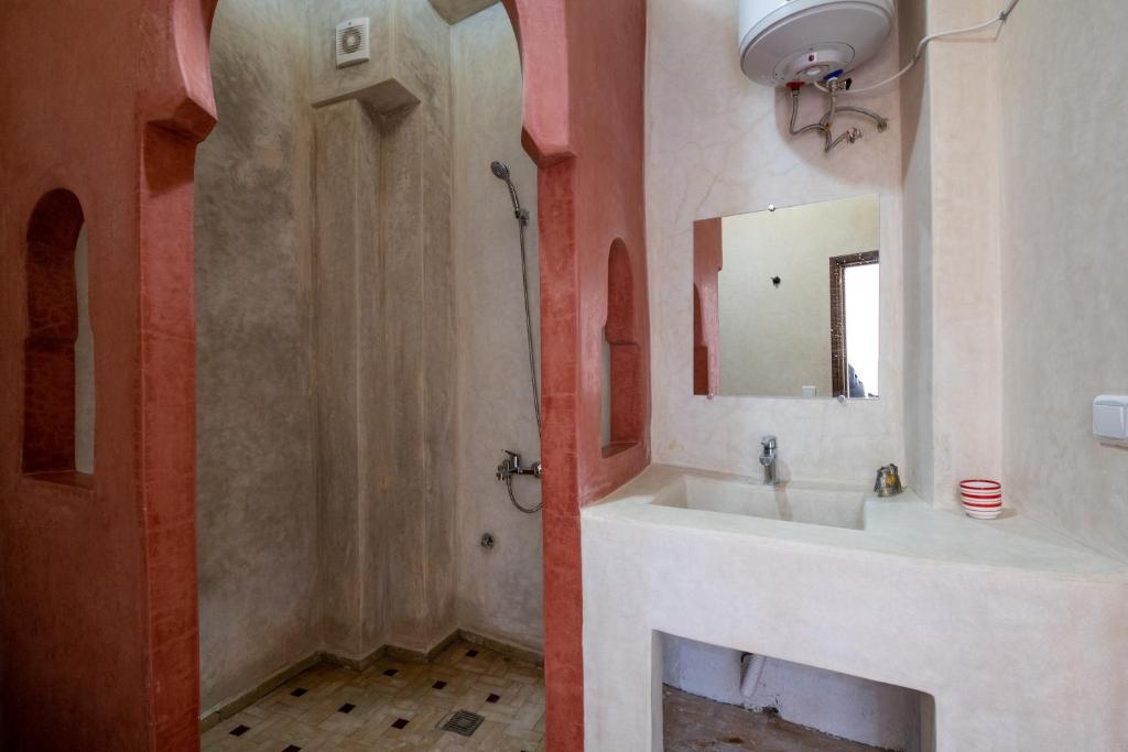 a bathroom with a sink and a mirror at Riad SULTANA in Tangier