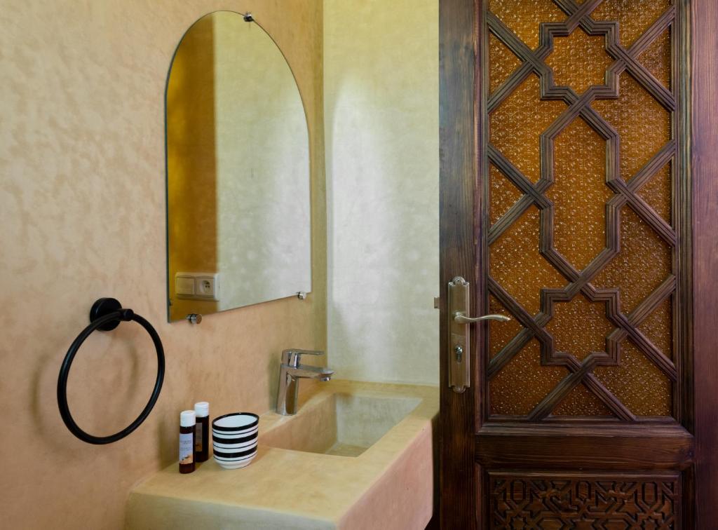 a bathroom with a sink and a mirror at Riad SULTANA in Tangier