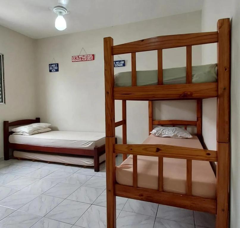 a room with two bunk beds in a room at Kit Ocian in Praia Grande