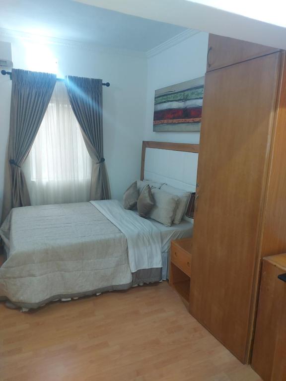 a bedroom with a bed and a window at Cute Studio at lekki in Lagos