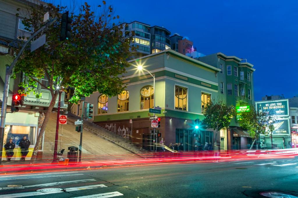 a city street at night with buildings and street lights at Green Tortoise Hostel in San Francisco
