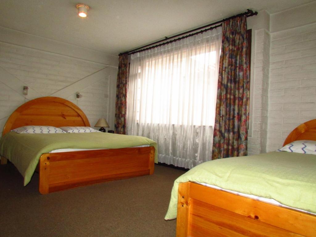Postel nebo postele na pokoji v ubytování Apartamentos Los Quipus