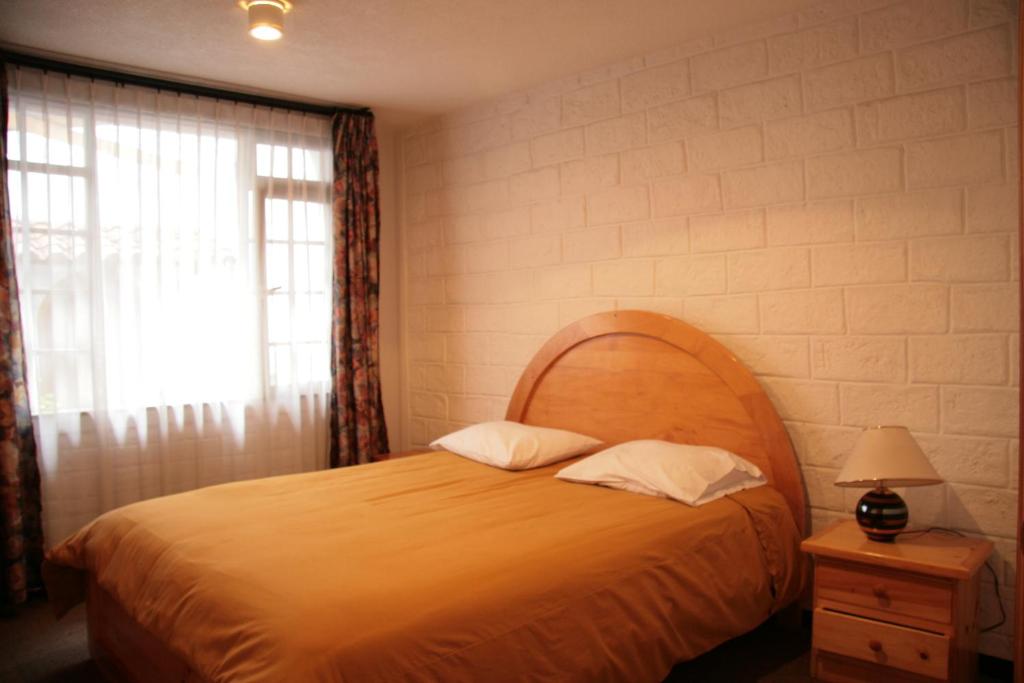 Postel nebo postele na pokoji v ubytování Apartamentos Los Quipus